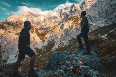 Scenic view of two hikers in front of the Hochtor mountain range at GesÃ¤use National Park in the...