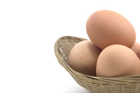 Eggs in basket isolated on white white background