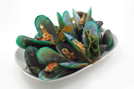group of mussels boiled with garlic and parsley isolated on white backgroundの写真素材