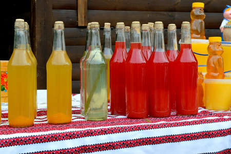Ukrainian national alcoholic beverages with herbs, berries and fruit. colorful, bright, tastyの写真素材