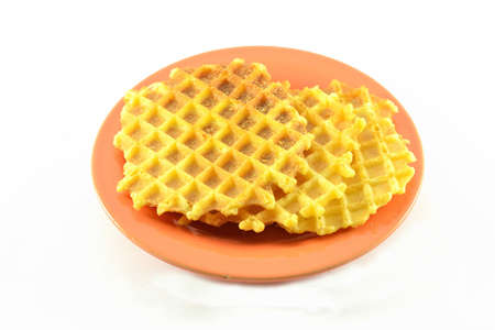 Isolated image. roasted savory waffles on a brown saucer. delicious dessert on a white background.の写真素材
