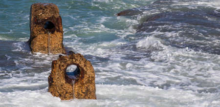 a rocks with holes in the portの写真素材