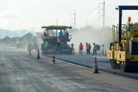 Road construction works with roller compactor machine and asphaltの写真素材