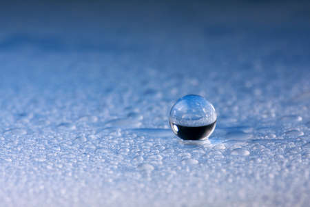 Beautiful water drop on blue petals, super macroの写真素材