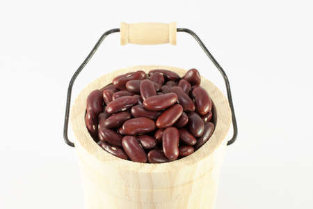 Wooden cask of red beans isolated on white backgroundの写真素材