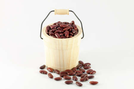 Wooden cask of red beans isolated on white background