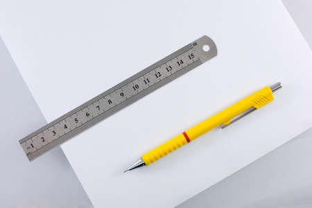 stationery - ruler, paper and a pencil are isolated on a white background.