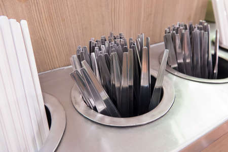 many pair of spoon and fork in hot waterの写真素材