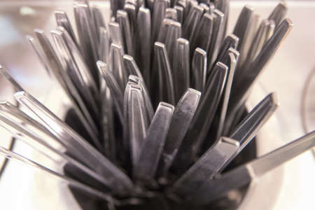 many pair of spoon and fork in hot waterの写真素材