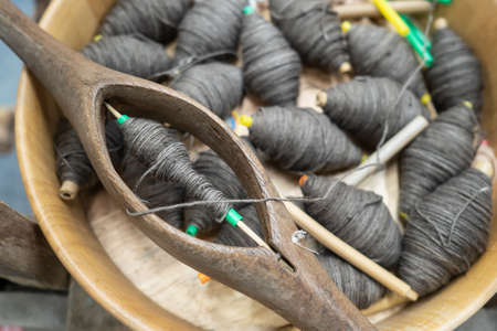Closeup of old weaving machine, weaving of yarn, thread and thread.