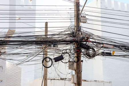 Chaos of cables and wires on electric pole in chiang mai,thailand.の写真素材