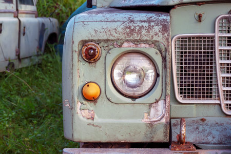 Ancient car abandoned in the countryside and illuminated with lanternsの写真素材