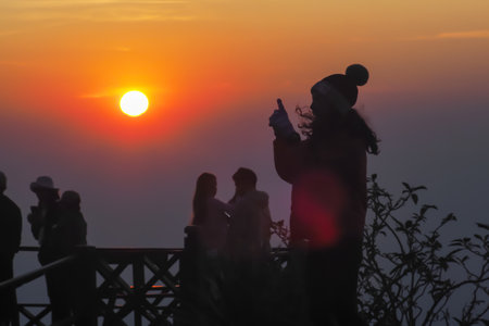asians travel relax in the holiday.People stand looking at the sun in the morning. Stand up for...