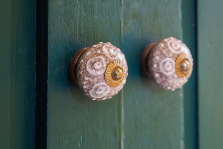 The old vintage retro door made of hardwood with ornate knobsの写真素材
