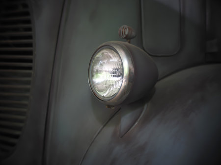 Headlight and part of hood of an old red and  vintage carの写真素材
