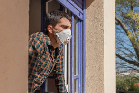 Coronavirus. Quarantine. Isolated confined at home. Man with mask virus outbreak.の写真素材