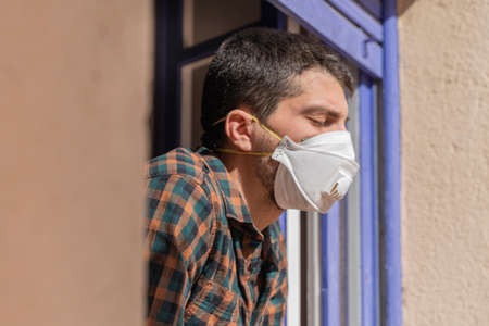 Coronavirus. Quarantine. Isolated confined at home. Man with mask virus outbreak.の写真素材