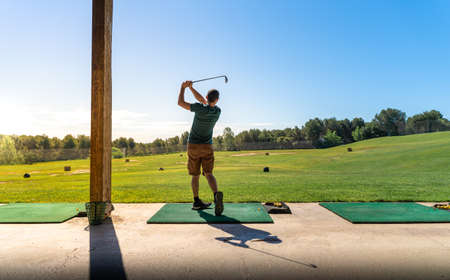 Young man playing golf in summer. Unrecognizable person.の写真素材