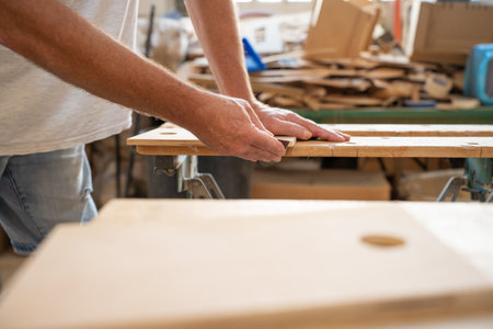 Carpenter working on wood craft at workshop. Professional tools for crafting. DIY maker and carpentry work concept. Copy space for text.の写真素材