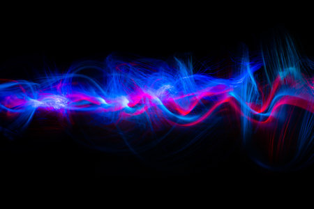 Abstract technology banner design. Long exposure, light painting. Vibrant streaks of digital neon lines on black background.の写真素材