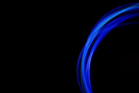 Abstract modern banner design. Glowing neon lines circle on black background.の写真素材