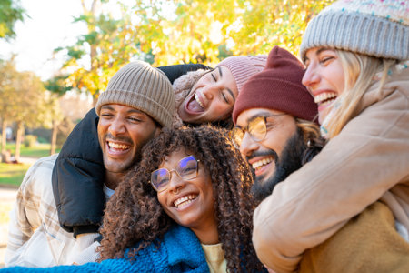 Cheerful group of friends taking smiling selfie. Happy people having fun together outdoors.の写真素材