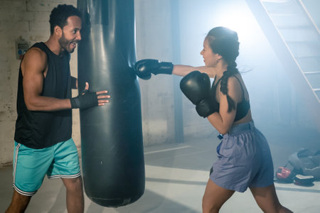 Fit and Strong Multicultural Couple Practicing Boxing Together in the Gym, Promoting Health and Unitの写真素材
