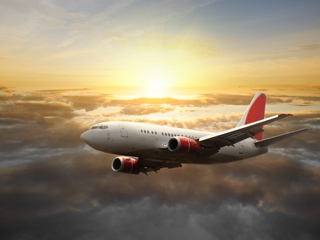 Airplane in the sky at sunset - Passenger Airliner / aircraft の写真素材