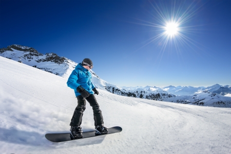 Snowboarder on piste in high mountainsの写真素材