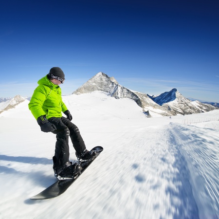 Snowboarder on piste in high mountainsの写真素材