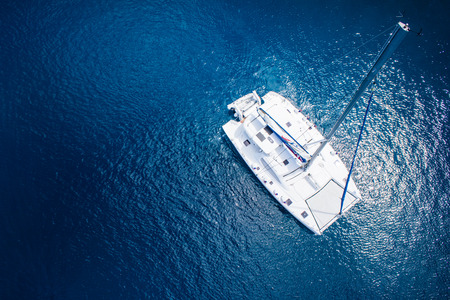 amazing view to catamaran, swimming woman and clear water caribbean paradiseの写真素材