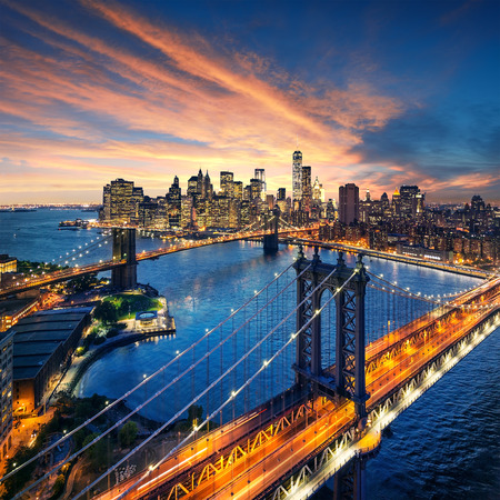New York City - beautiful sunset over manhattan with manhattan and brooklyn bridgeの写真素材