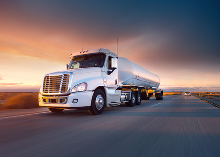 Truck cistern and highway at sunset - transportation backgroundの写真素材