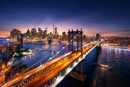 New York City - beautiful sunset over manhattan with manhattan and brooklyn bridgeの写真素材