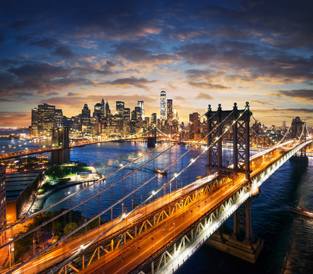 New York City - beautiful sunset over manhattan with manhattan and brooklyn bridgeの写真素材