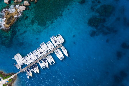 Amazing view to Catamaran cruising in open sea at windy day. Drone view - birds eye angle Coco Island.の写真素材