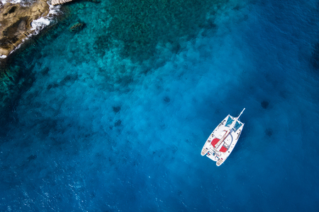 Amazing view to Catamaran cruising in open sea at windy day. Drone view - birds eye angle Coco Island.の写真素材