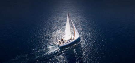 Amazing view to Yacht sailing in open sea at windy day. Drone view - birds eye angle.の素材 [FY310100284904]