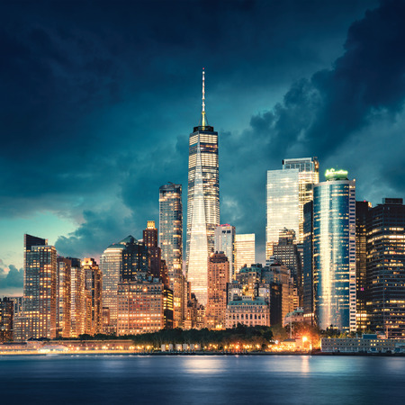 New York City Manhattan detail with skyscrapers at dramatic sunset. River and waterfront park in front. Photo taken from Governors Island.の写真素材