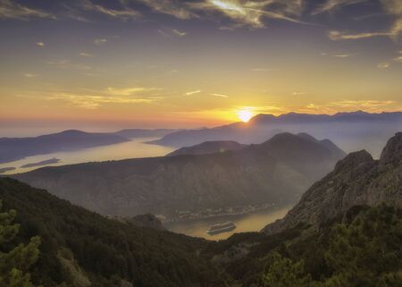 Kotor bay seen from above in a beautiful sunset summer day. Tourist liners on the pier. Montenegro....