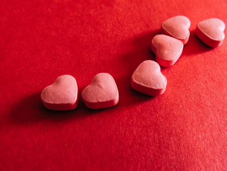 Love Heart medicine on red background. Valentines day.の写真素材