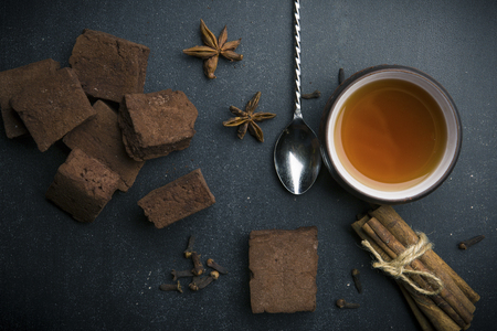 Cup of tea and delicious ingredients on tableの写真素材