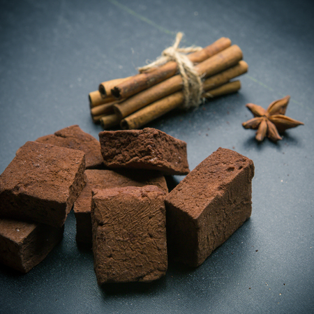 brown chocolate marshmallows with spices on the dark background. Cinnamon, star anise.の写真素材