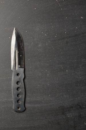 combat knife blade on dark backroundの写真素材