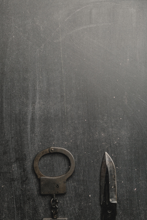 Metal handcuffs with dark background, top view.の写真素材