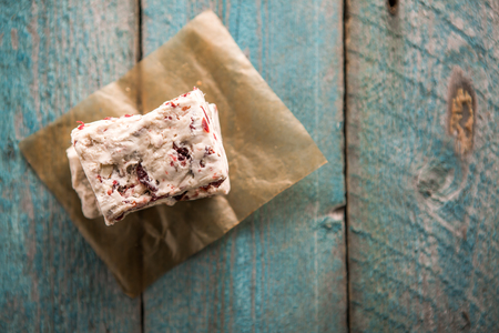Hard nougat on wooden background, top viewの写真素材