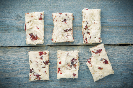 Six pieces of white Nougat Turron on wodden background top viewの写真素材