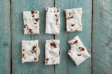Six pieces of white Nougat Turron on wodden background top viewの写真素材