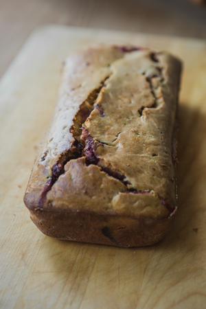 Loafes of fresh baked bread with black currant berriesの写真素材