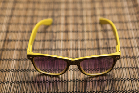 Sunglasses on bamboo matの写真素材
